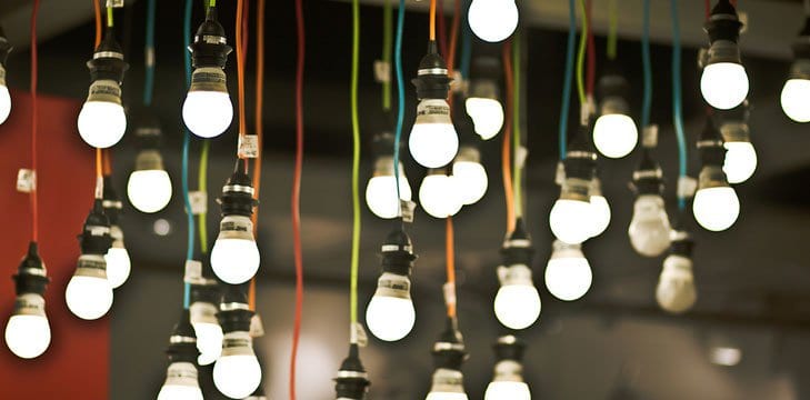 A photograph of many lit hanging light bulbs. 