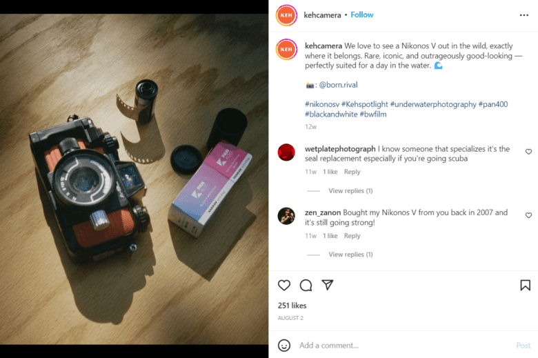 K E H Camera Instagram photo, showing a film camera and film rolls on a partly-shaded wood background. Caption: We love to see a Nikonos V out in the wild, exactly where it belongs. Rare, iconic, and outrageously good-looking — perfectly suited for a day in the water.