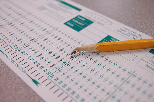 A photograph of a bubble answer sheet and a broken pencil. 