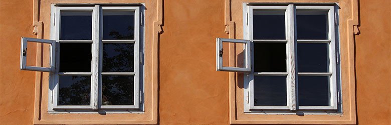 A photograph of two windows on a wall.