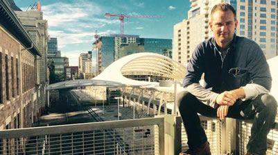 A photograph of Everett Sizemore sitting on a rooftop in Denver.