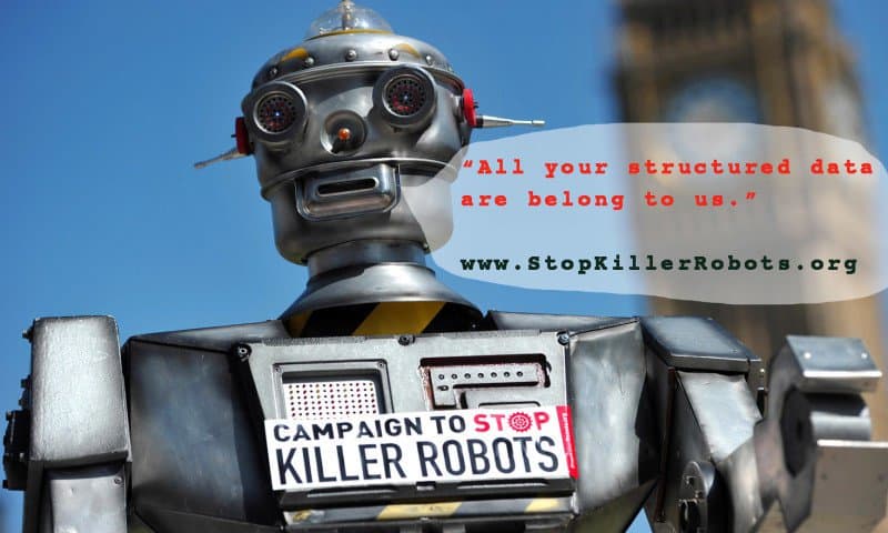 A photograph of a robot wearing a sign with text: Campaign to stop killer robots. An illustrated conversation bubble with text: All your structured data are belong to us." www.stopkillerrobots.org.