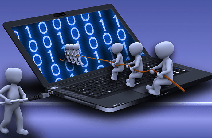 An illustration of six figures playing tug-of-war with three standing on the keyboard of a laptop and three within the screen. 