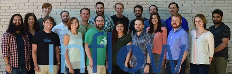 A photograph of the Inflow Team. A group of 19 people smile at the camera.