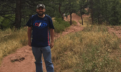 A photograph of Mike Belasco on a hiking trail.