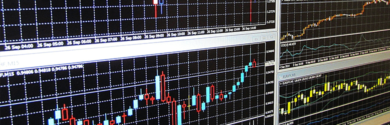 A close-up photograph of a computer screen displaying five graphs. 