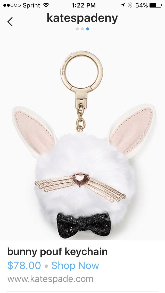 Kate spade Instagram photograph of bunny pouf keychain. Below the photograph is the product title, price, Shop Now link, and Kate Spade U R L. 