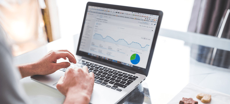 ppc-auditing A photograph of a person working on a laptop displaying a report.