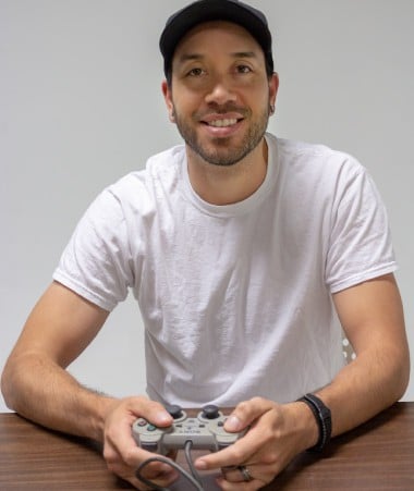 Alex Juel holding a video game controller.