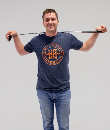 Shane Klein holding a golf club.
