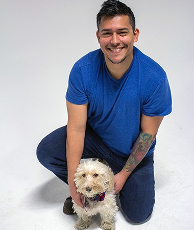 Cear Tellez with a small dog.