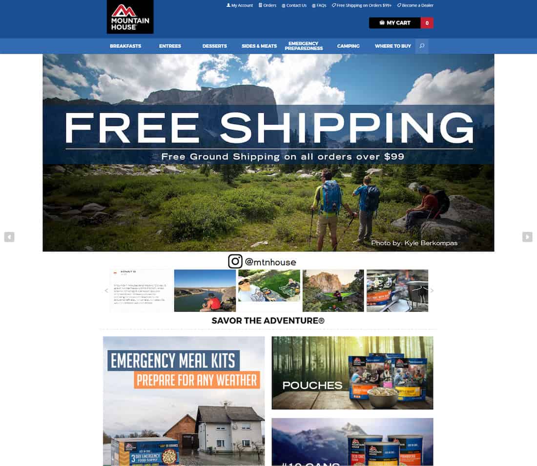 Mountain House homepage screenshot. Beneath the menu bar, a photograph of three people outdoors in nature by Kyle Berkompas with the text Free Shipping. Beneath Mountain House Instagram page followed by a carousel of photographs from Instagram users. 