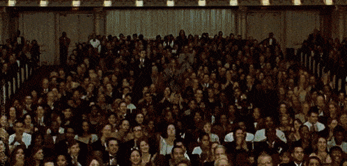 standing-ovation A gif of an audience in a theater standing up and clapping.