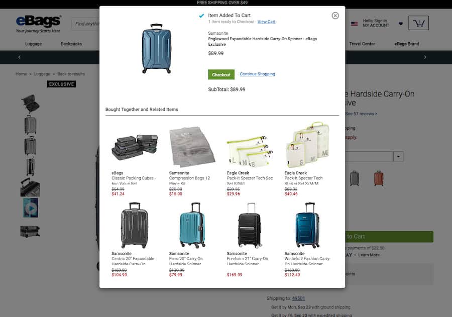 ecommerce-upselling-13 Ebags product added to cart modal screenshot. At the top, a section titled "Item added to cart" followed by the item: a Samsonite suitcase. Below a section titled: "Bought together and related items" featuring 8 items with a photograph, name and price.