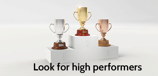 A photograph of three trophies on a winner podium. Text states: Look for high performers. 