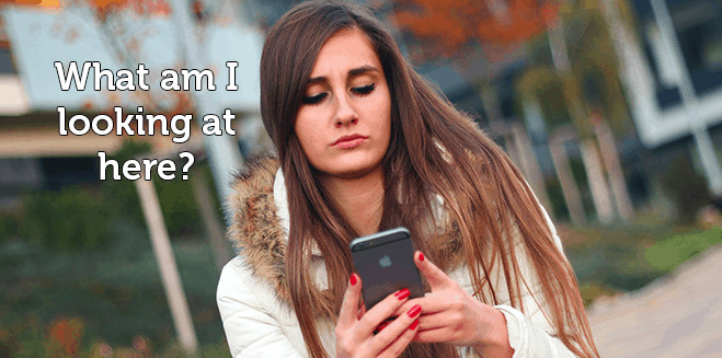 A photograph of a woman looking at her phone. Text states: What am I looking at here?