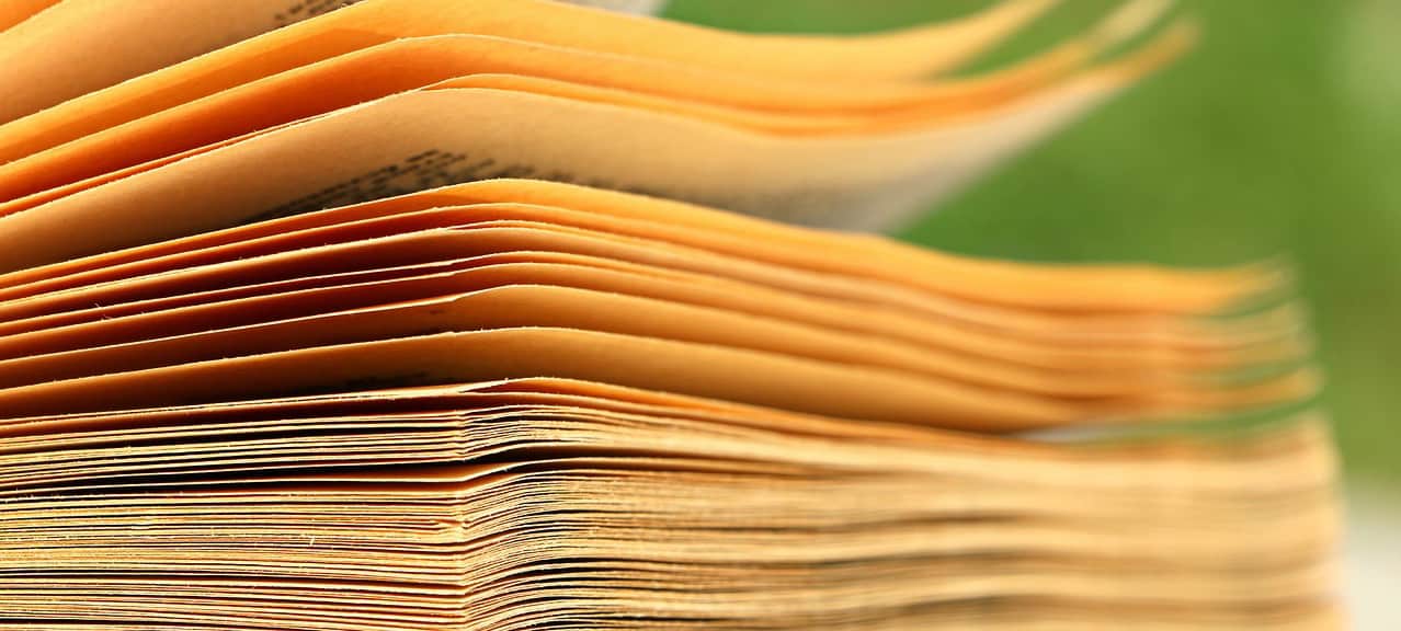 pagination A photograph of the side of a book with the yellowed pages separated slightly.