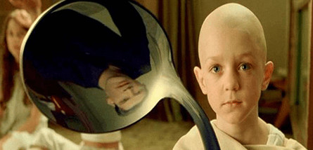 A photograph of Neo from the Matrix reflected on a spoon. 