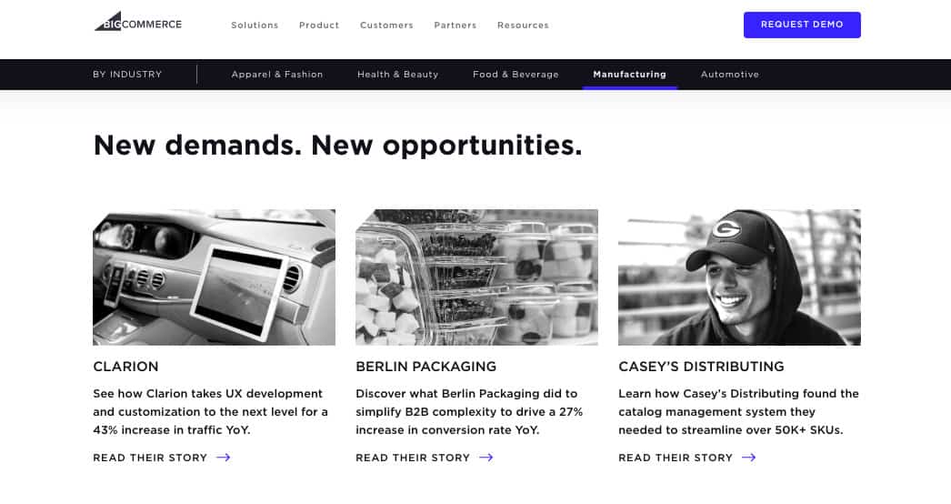 BigCommerce website screenshot. Tabs across the top of the page are labeled: By industry: Apparel & Fashion, Health & Beauty, Food & Beverage, Manufacturing, Automotive. The Manufacturing tab is selected. Text at the top of the page states: New demands. New opportunities. Beneath are links to three case studies, each with a short description and a photograph. 