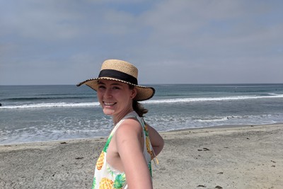 A photograph of Kate Miller at a beach. 