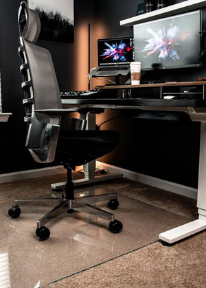 A photograph of a glass chair mat being used in an office setting. 