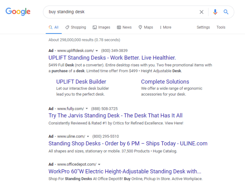 Google-Search-Ads-example A screenshot of a Google search result for buy standing desk. Each ad is text only and includes a short description.