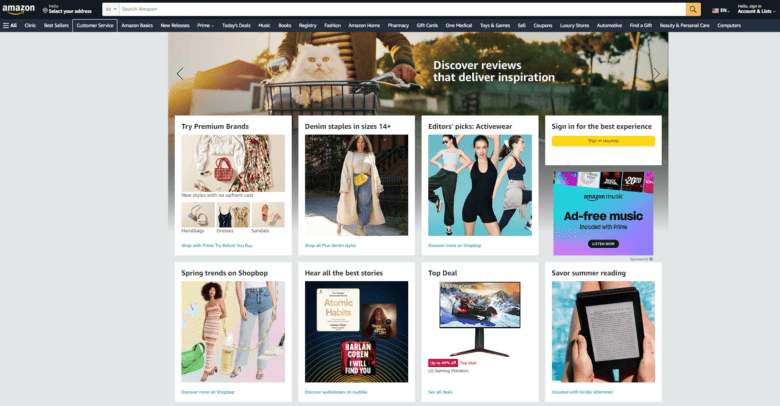 Amazon.com desktop homepage. Hero image of a cat in a bicycle basket. Caption: Discover reviews that deliver inspiration. Grid of categories listed below: Try Premium Brands. Denim staples in size 14+. Editors' picks: Activewear. Spring trends on Shopbop. Hear all the best stories. Top Deal. Savor summer reading.