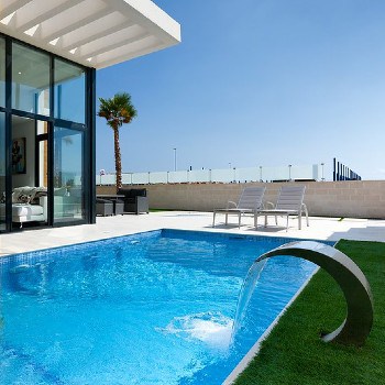 A photograph of a pool in a yard. 