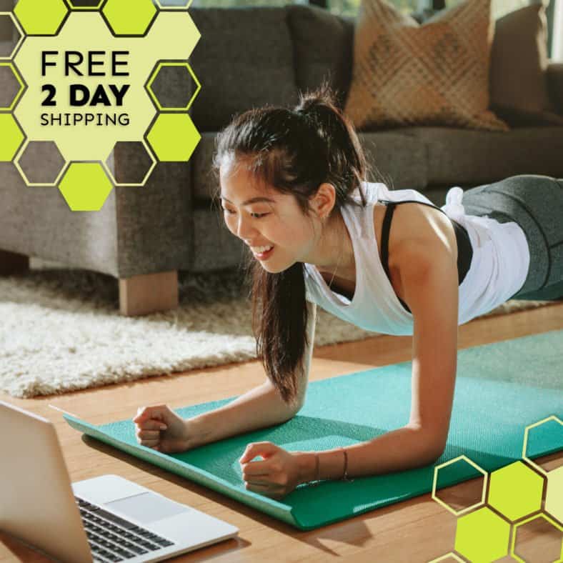 A photograph of a smiling woman in plank position on a yoga mat and looking at a laptop screen. Text states: Free 2 day shipping. 