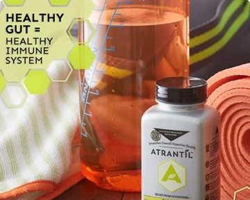 A photograph of an Atrantil bottle with a glass container with measurement lines and a yoga mat in the background. Text states: Healthy gut equals healthy immune system. 