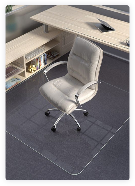 A photograph of an office chair on a glass chair mat. 