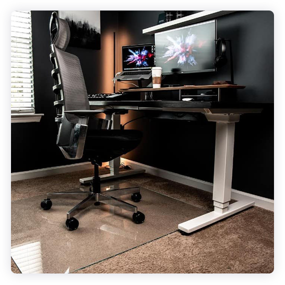 A photograph of a glass chair mat in a home office setting. 