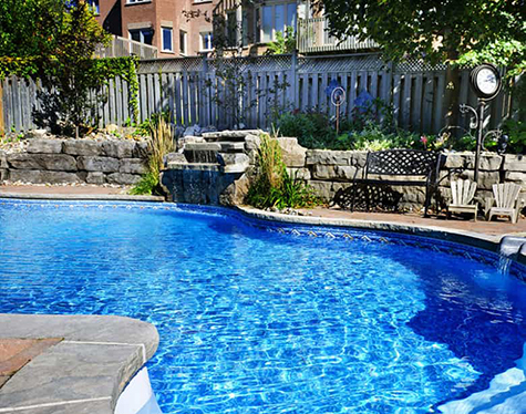 A photograph of a pool in a yard. 