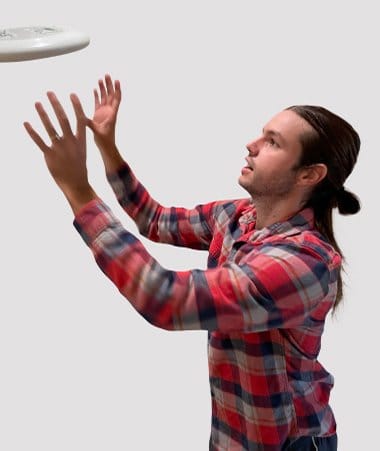 Corey Bennett, Sr. Paid Social Strategist, catching a Frisbee