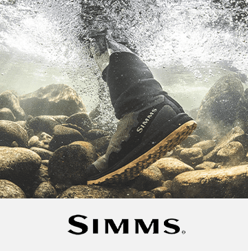 Simms labeled boot stepping on rocks underwater. Logo: Simms.