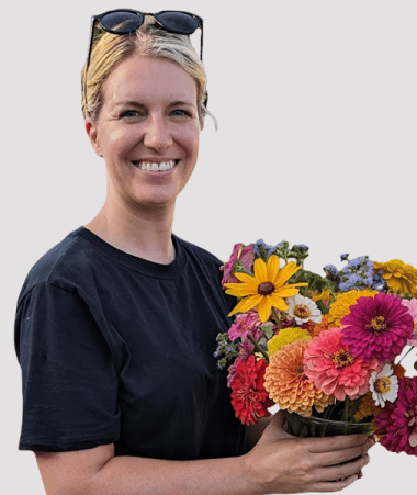 Aimee Heck, Senior Paid Social Strategist, holding a bouquet of flowers.